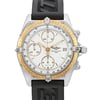An image of a pre-owned Breitling men's wristwatch in a casual style, shown in a front close-up view with the watch face in focus. The watch features a white dial with a gold bezel and stick indexes, enclosed in a round stainless steel case. Minor nicks are visible on the bezel, indicating previous use. The black rubber band displays signs of wear. The image is taken from a straight-on angle, capturing the entire face and a portion of the strap, 