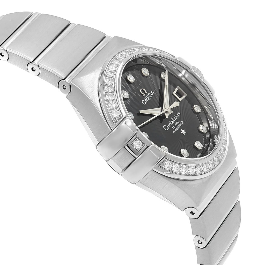 An image of a luxury Omega wristwatch for women, displayed in a side profile view opposite of the crown. The watch features a round shape with a black dial and luminous hands, including a date indicator. It is adorned with diamonds around the bezel and on the dial as hour markers. The band and case are made of white gold, and the watch is positioned at a close distance, angled to showcase its side profile and intricate details.
