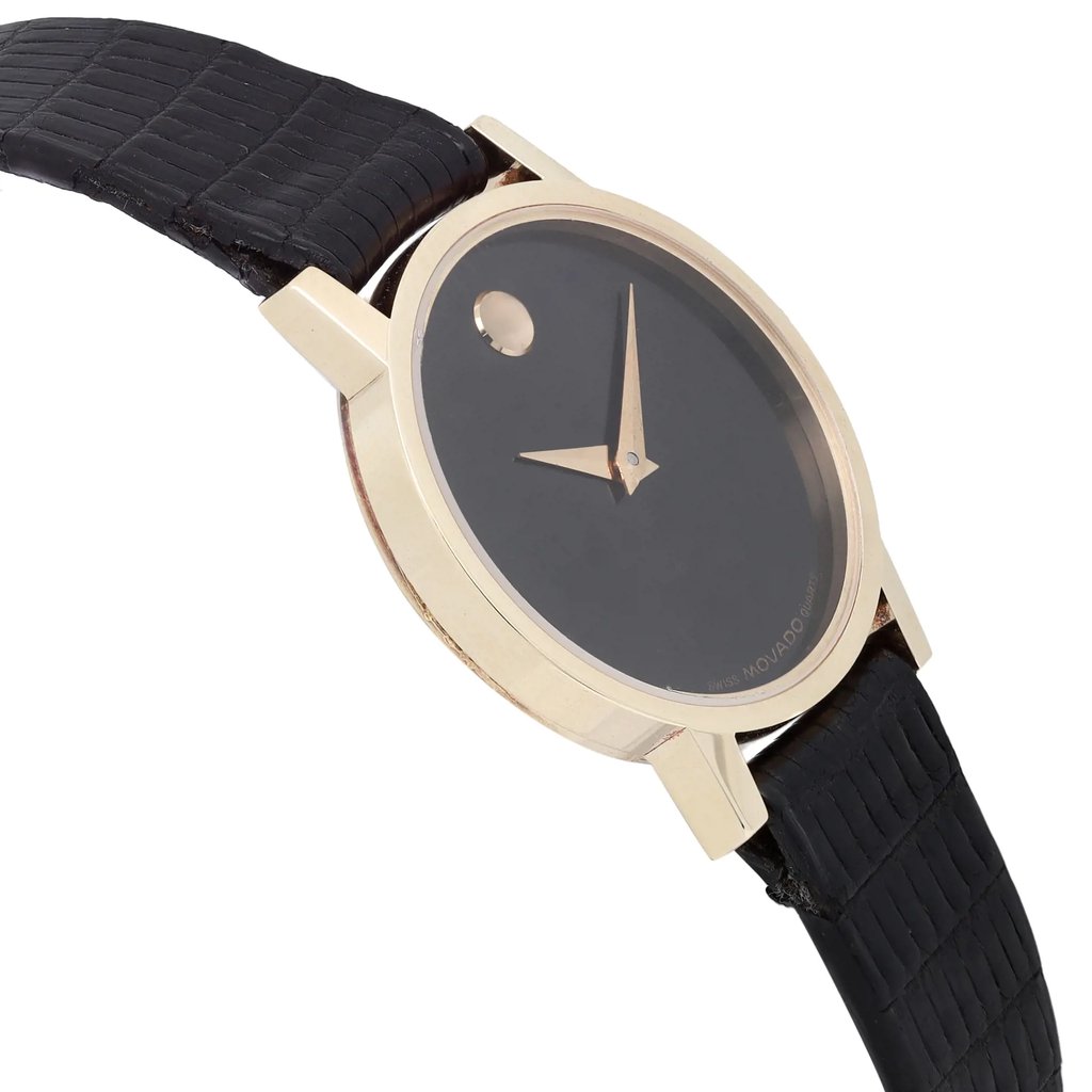 An image of a pre-owned wristwatch captured from a side profile view, opposite the crown. The watch features a sleek, minimalist design with a black dial and gold-toned hands. The case is elegantly round, and the strap is textured in a dark color. The angle highlights the side of the watch, emphasizing its thin profile and the absence of a crown on the visible side.