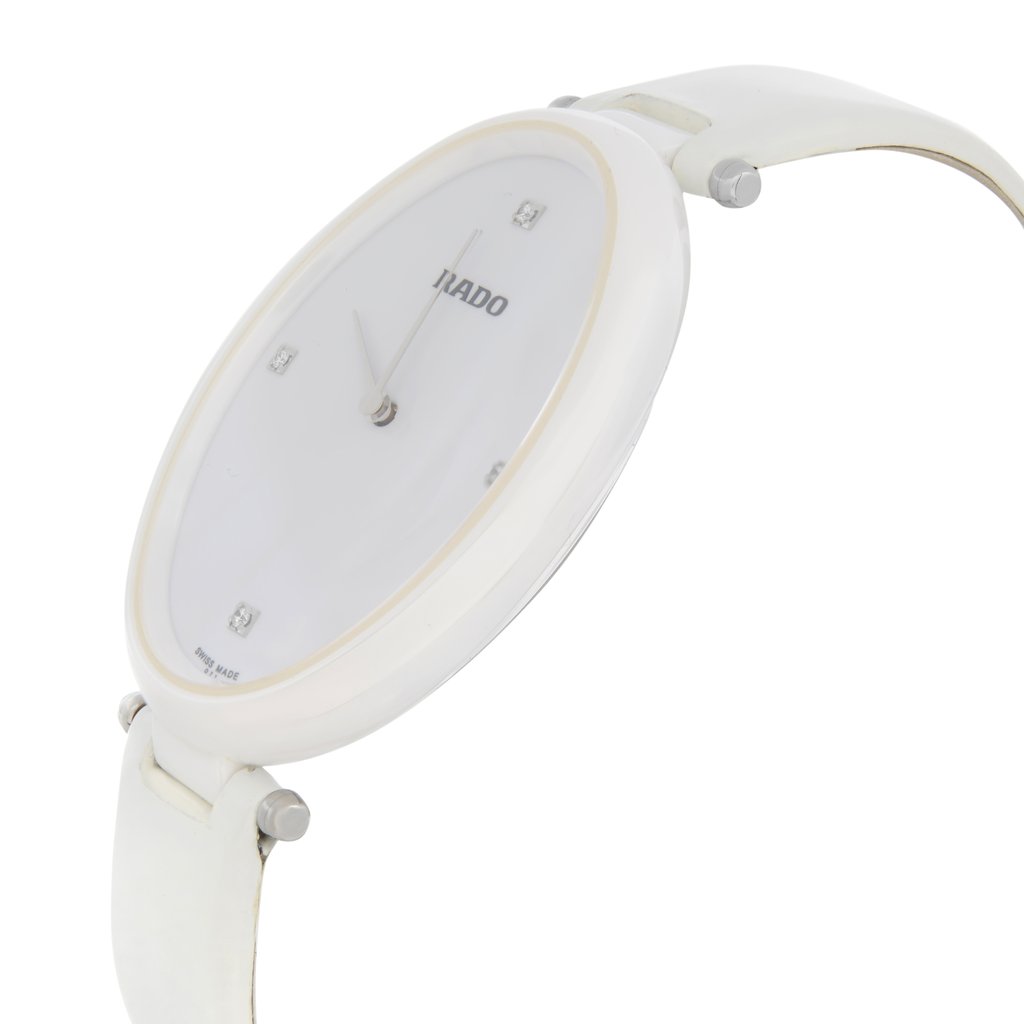 An image of a wristwatch shown from a side profile view, highlighting the crown on the right side. The watch has a sleek, white design with a minimalist dial. The angle captures the thinness of the watch case and the curvature of the strap. The watch is in new condition, but with defects noticeable upon closer inspection. The image is taken at a close distance, allowing for detailed observation of the timepiece's features.