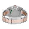 An image of a pre-owned Rolex men's wristwatch, viewed from the back showing the screwback case and closed fold-over clasp. The watch is positioned centrally and photographed at a close distance, capturing the entire back view. The stainless steel caseback is round with minor scratches visible, and a sticker is present. The band is composed of alternating links of stainless steel and rose gold. The Rolex crown logo is embossed on the clasp, and the watch is angled to display the band's profile and closure mechanism.