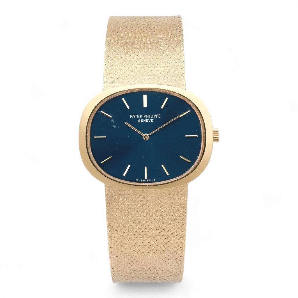 An image of a pre-owned unisex Patek Philippe Ellipse 18k Yellow Gold Blue Dial Manual Wind Watch 3583. The watch is positioned upright, with a direct frontal view, showcasing its oval-shaped  yellow gold case and textured gold strap. The dial is blue with minimalistic gold hour markers and hands. The watch is captured at a close distance against a plain white background.