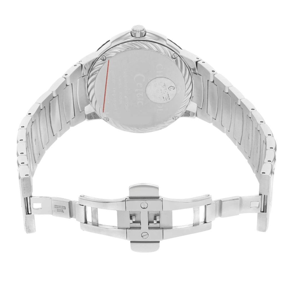 An image of a wristwatch displayed from the back view, showcasing an open clasp. The watch is positioned at a slight angle to emphasize the metallic bracelet and the detailed design of the clasp. The image is taken from a close distance, highlighting the condition of the watch as a display model. The focus is primarily on the back casing and the intricate links of the strap.