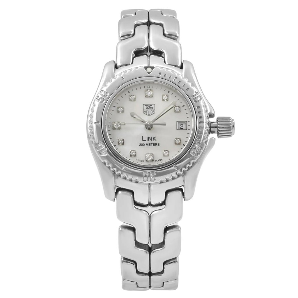 An image of a Wristwatch by TAG Heuer. This Pre Owned item is designed for Women, featuring a Dress/Formal style. It has a Quartz movement and an Analog display with a White Mother Of Pearl dial color. The indices include 12-Hour Dial,Diamond Markers. The band is made of Stainless Steel and the case is made of Stainless Steel. The watch has a Round shape with a case size of 26 mm and a case thickness of 9 mm.