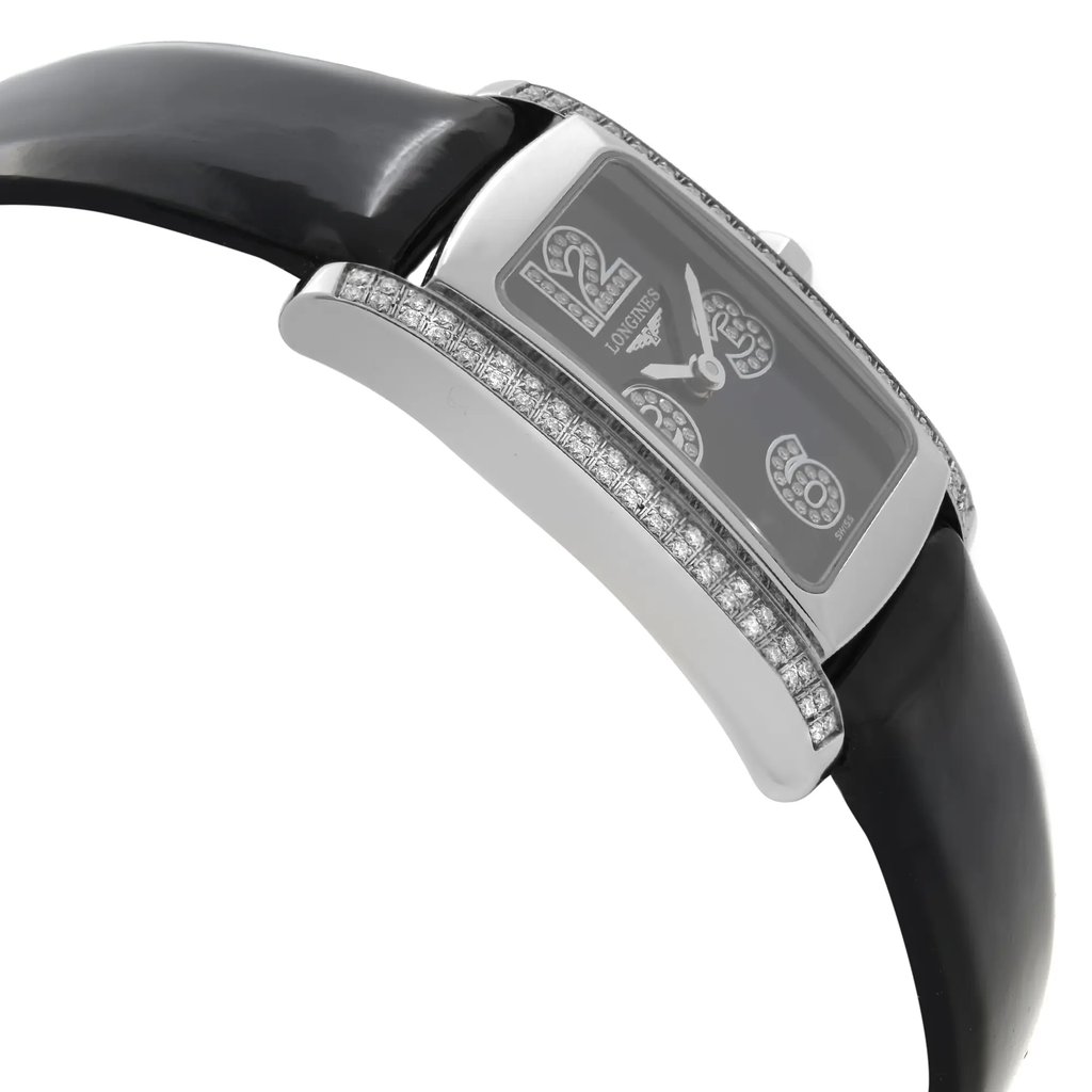 An image of a wristwatch taken from a side profile view, opposite the crown. The watch features a sleek, rectangular face adorned with sparkling stones around the bezel. The black strap is partially visible, showing its smooth texture. The display model is positioned at a slight angle, highlighting the elegant curve of the watch case from a close distance.