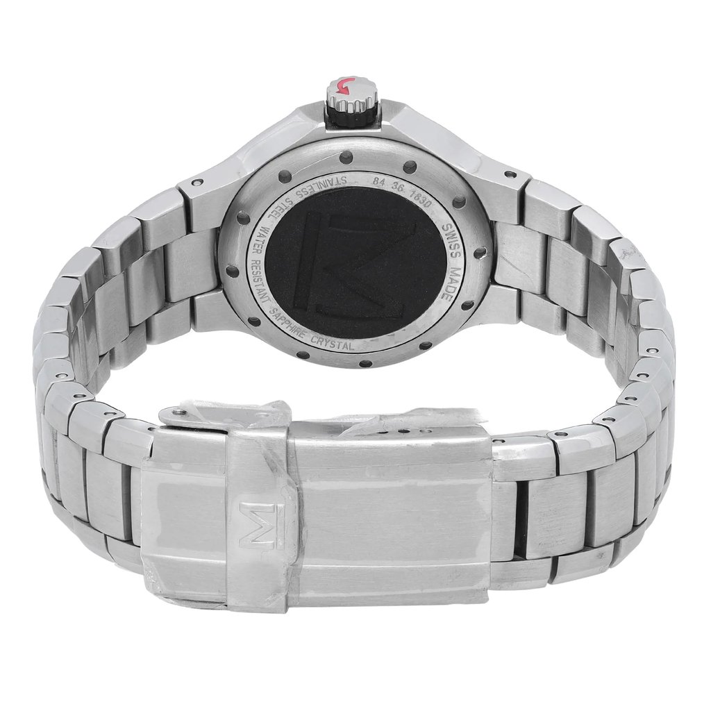 An image of a pre-owned wristwatch, viewed from the back at a close distance. The focus is on the stainless steel clasp, which is centered and prominently displayed. The watch's metal bracelet extends symmetrically to either side, and the back of the watch case is visible with engraved details, including the words "Swiss Made" and other specifications. The crown with a red accent is visible at the top.