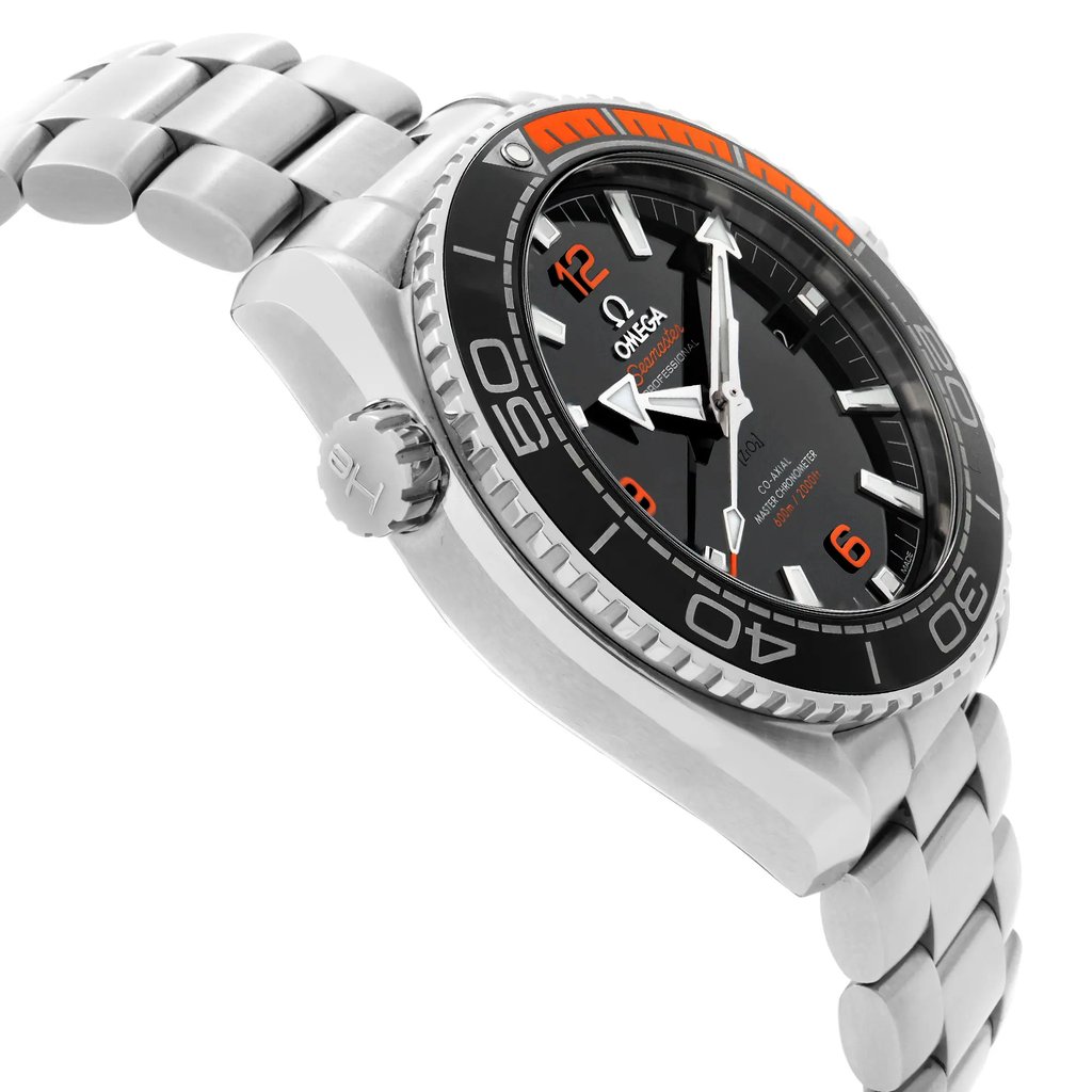 An image of a wristwatch captured from a side profile view, opposite the crown. The angle showcases the watch's metallic bracelet and detailed bezel with orange and black accents. The watch face is partially visible, highlighting the hour markers and hands. The image is taken at a close distance, emphasizing the watch's design and craftsmanship.