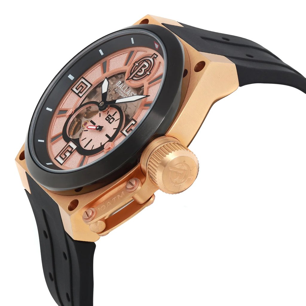 An image of a Wristwatch by BALLAST. This Pre Owned item is designed for Men, featuring a Casual style. It has a Mechanical (Automatic) movement and an Analog display with a Rose Gold dial color. The indices include 12-Hour Dial,Arabic Numerals,Stick Indexes. The band is made of Silicone and the case is made of Stainless Steel. The watch has a Round shape with a case size of 47 mm and a case thickness of 14 mm.