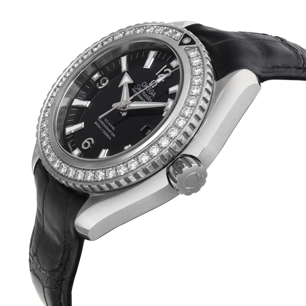An image of a pre-owned wristwatch taken from a side profile view, showcasing the crown prominently. The watch has a black dial with silver hour markers and hands. The bezel is encrusted with sparkling stones, adding a touch of elegance. The watch strap is black and textured, complementing the sleek design. The angle provides a clear view of the watch's thickness and detailed craftsmanship.
