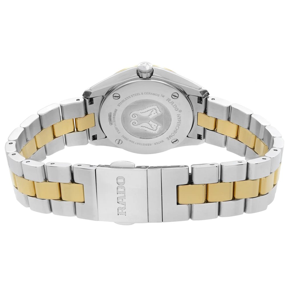 An image of a wristwatch displayed from the back view, showcasing the closed clasp. The watch features a two-tone metal bracelet in silver and gold. The angle is slightly elevated and close-up, highlighting the brand name engraved on the clasp and the details on the case back. The condition appears to be that of a display model, with a focus on the craftsmanship and design elements.