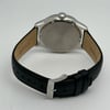 An image of a Wristwatch by Seiko. This Display Model item is designed for Men, featuring a Casual style. It has a Quartz movement and an Analog display with a Black dial color. The indices include 12-Hour Dial,Arabic Numerals,Non-Numeric Hour Marks. The band is made of Leather and the case is made of Stainless Steel. The watch has a Round shape with a case size of 42 mm and a case thickness of 11 mm.