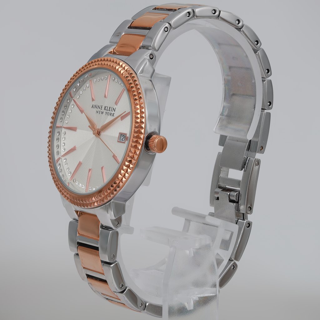 An image of a Wristwatch by Anne Klein. This Pre Owned item is designed for Women, featuring a Casual,Dress/Formal style. It has a Quartz movement and an Analog display with a White dial color. The indices include 12-Hour Dial,Stick Indexes. The band is made of Stainless Steel and the case is made of Stainless Steel. The watch has a Round shape with a case size of 36 mm and a case thickness of 8 mm.