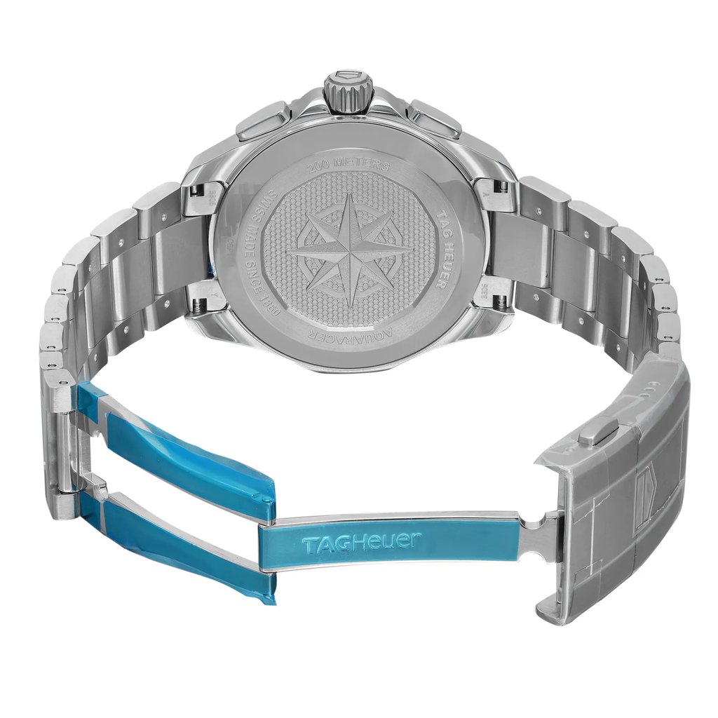 An image of an unworn TAG Heuer men's wristwatch, viewed from the back with an open clasp. The watch is positioned at a slight angle, allowing a clear view of the stainless steel screwback case displaying the brand's logo and other details. The stainless steel band is also visible, with its fold-over clasp featuring a double push-button release, partially extended at a medium distance from the camera. The protective blue film is still on the clasp, indicating the new condition of the watch.