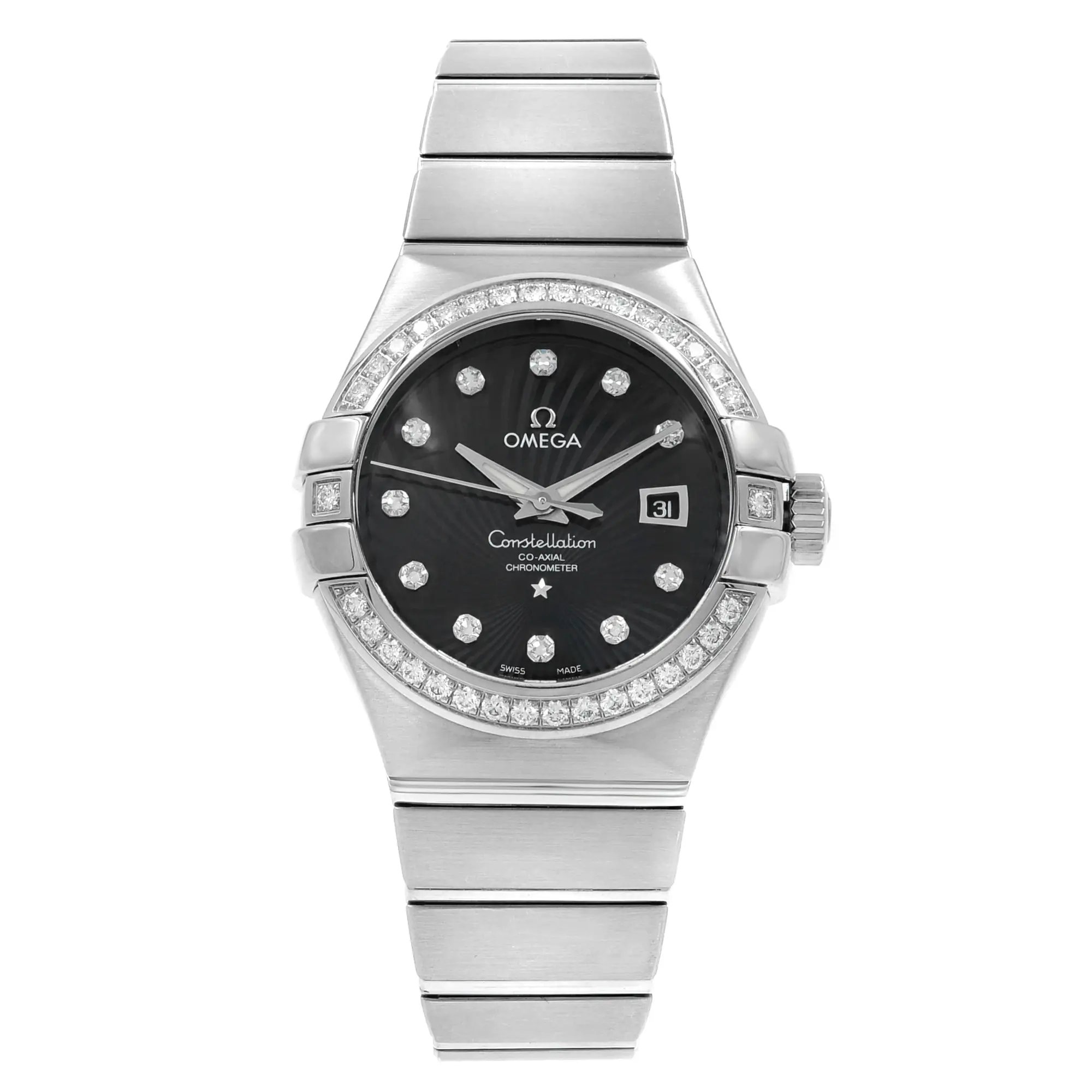 An image of an OMEGA Constellation women's wristwatch displayed from a front-facing angle at a close distance. The watch features an 18k white gold band and a black dial with diamond hour markers. It includes a date indicator and luminous hands, and the bezel is adorned with diamonds. The overall condition appears to be a display model.