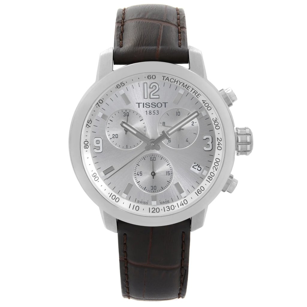 An image of a Wristwatch by Tissot. This Pre Owned item is designed for Men, featuring a Dress/Formal style. It has a Quartz movement and an Analog display with a Silver dial color. The indices include 12-Hour Dial,Arabic Numerals,Seconds Hand,Stick Indexes. The band is made of Leather and the case is made of Stainless Steel. The watch has a Round shape with a case size of 42 mm and a case thickness of 12 mm.