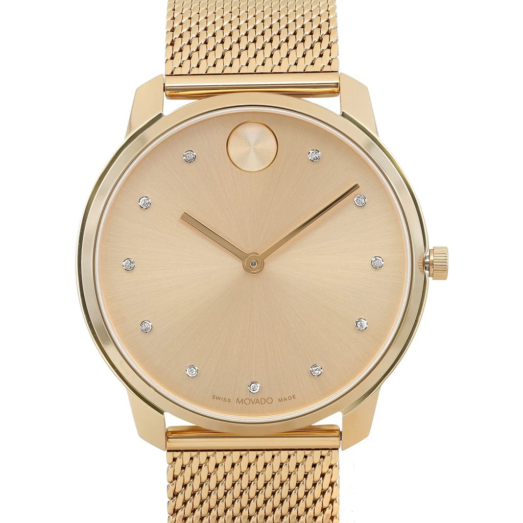 An image of a pre-owned wristwatch captured in a front close-up shot, focusing on the watch face. The watch features a sleek, minimalist design with a gold dial and simple hour markers. The case and mesh band are also gold, complementing the elegant appearance. The watch hands are thin and match the gold theme, and a small crown is visible on the right side.