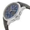 An image of a Breitling men's luxury wristwatch, displayed in a side profile view with the crown visible. The watch features a round stainless steel case and a steel bezel. It has a blue sunburst dial with silver-tone hands and markers, and a grey leather band. The watch is positioned at a slight angle to show the side profile, and it is photographed up close against a white background, highlighting its design. The watch is a display model and has never been worn, there may be minor blemishes on the band due to store handling.