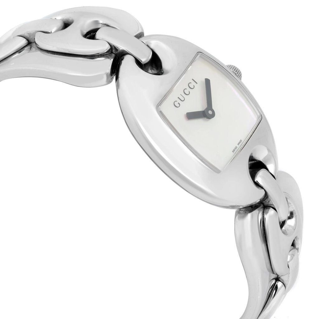 An image of a pre-owned women's Gucci wristwatch. The watch is positioned at a slight angle, showcasing its elegant silver chain-link band and rectangular face. The photo is taken at a close distance, highlighting the brand name on the dial and the sleek design of the watch.