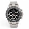 An image of a pre-owned men's Rolex Cosmograph Daytona Ceramic Steel Black Dial Automatic Watch 116500LN positioned front and center. The watch is angled slightly to the right, showcasing its chronograph features, luminous hands, and small seconds subdial. The focus is close-up, highlighting the intricate details of the watch's face and stainless steel bracelet.