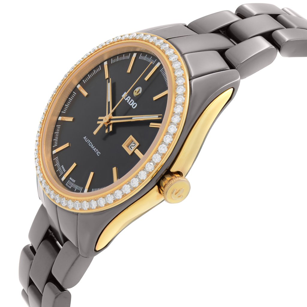 An image of a pre-owned Rado luxury women's wristwatch shown from a side profile view, highlighting the crown. The watch features a round brown dial with luminous hands and a date indicator. The bezel is gold with a ceramic band and a case made of ceramic and stainless steel. The watch is positioned at an angle to showcase its elegance and design details.