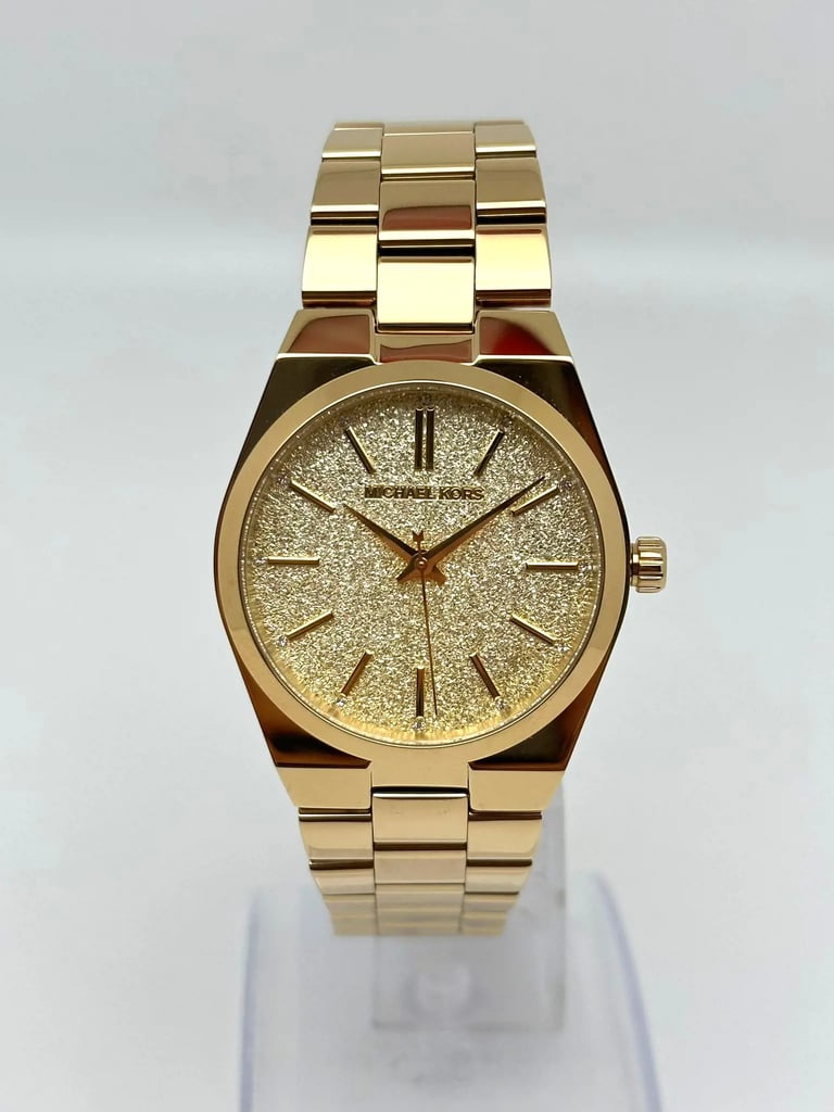 An image of a Wristwatch by Michael Kors. This New With Defects item is designed for Women, featuring a Classic,Dress/Formal style. It has a Quartz movement and an Analog display with a Champagne dial color. The indices include 12-Hour Dial,Seconds Hand,Stick Indexes. The band is made of Stainless Steel and the case is made of Stainless Steel. The watch has a Round shape with a case size of 36 mm and a case thickness of 8 mm.