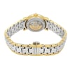 An image of a wristwatch showcasing its back view at a close distance. The watch features a two-tone metal bracelet with gold and silver links. The clasp is prominently displayed in the foreground, engraved with a logo. The watch's back reveals its internal mechanism, visible through a transparent case. The angle provides a clear view of the intricate design and craftsmanship.