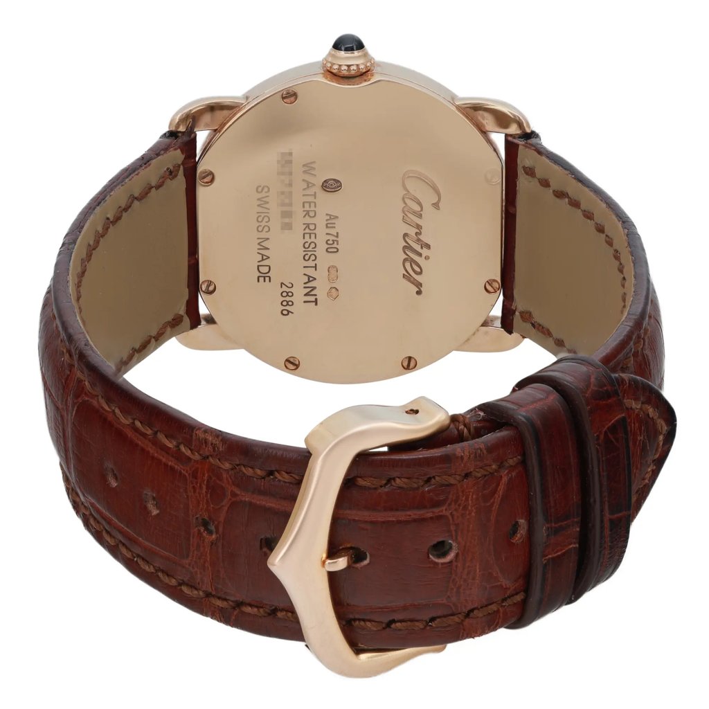 An image of a pre-owned wristwatch taken from the back view, showcasing the closed clasp. The focus is on the gold-toned case and detailed engravings. The watch features a brown leather strap with visible stitching, and the angle highlights the elegant curvature of the clasp. The photograph is taken at a close distance, capturing the watch's design and craftsmanship.