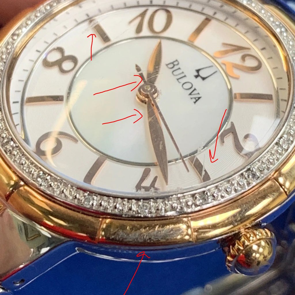 An image of a pre-owned Bulova wristwatch designed for women, featuring a casual and dress/formal style. The watch is presented in a front close-up shot, focused on the watch face, which is viewed at a slight angle to show depth. The round dial is white with a diamond pattern, accented with rose gold-tone stick indexes and Arabic numerals for 12-hour timekeeping. The bezel is adorned with sparkling accents, enhancing the rose gold-tone. The case and band are made of stainless steel, reflecting the watch's quality and durability. The watch hands are positioned in a way that suggests the time is approximately ten minutes past ten.