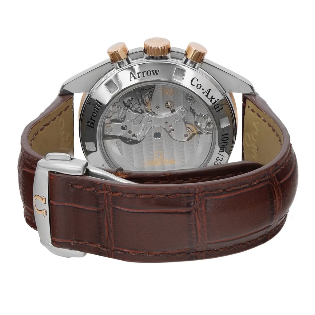 An image of a pre-owned wristwatch shown from the back view, focusing on the closed clasp. The watch has a transparent case back revealing its internal mechanism, with "Broad Arrow Co-Axial" inscribed. The watch is positioned upright with a brown leather strap featuring a visible clasp. The angle is straight-on and at a close distance, emphasizing the intricate details of the watch's movement and strap texture.