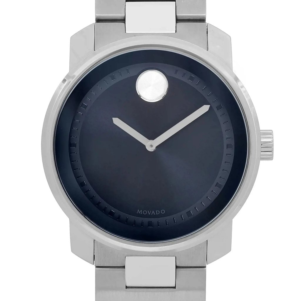 An image of a wristwatch captured from a front close-up angle, focusing on the watch face. The watch has a sleek, minimalist design with a dark dial and two simple hands. The case and bracelet are made of a shiny metal, and the crown is visible on the right side. The image highlights the watch as a display model.