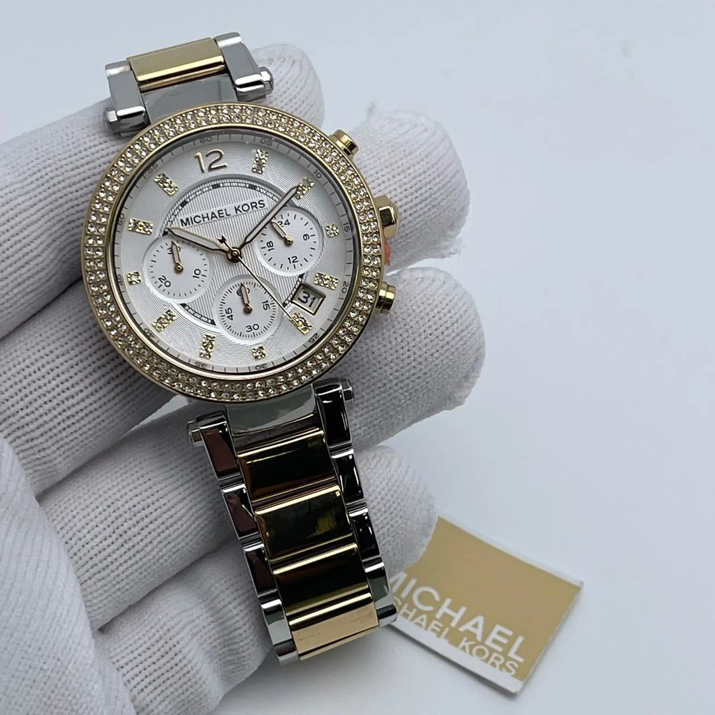An image of a Wristwatch by Michael Kors. This Pre Owned item is designed for Women, featuring a Dress/Formal style. It has a Quartz movement and an Analog display with a Silver dial color. The indices include 12-Hour Dial,Arabic Numerals,Multi Dial,Non-Numeric Hour Marks,Seconds Hand. The band is made of Stainless Steel and the case is made of Stainless Steel. The watch has a Round shape with a case size of 39 mm and a case thickness of 12 mm.