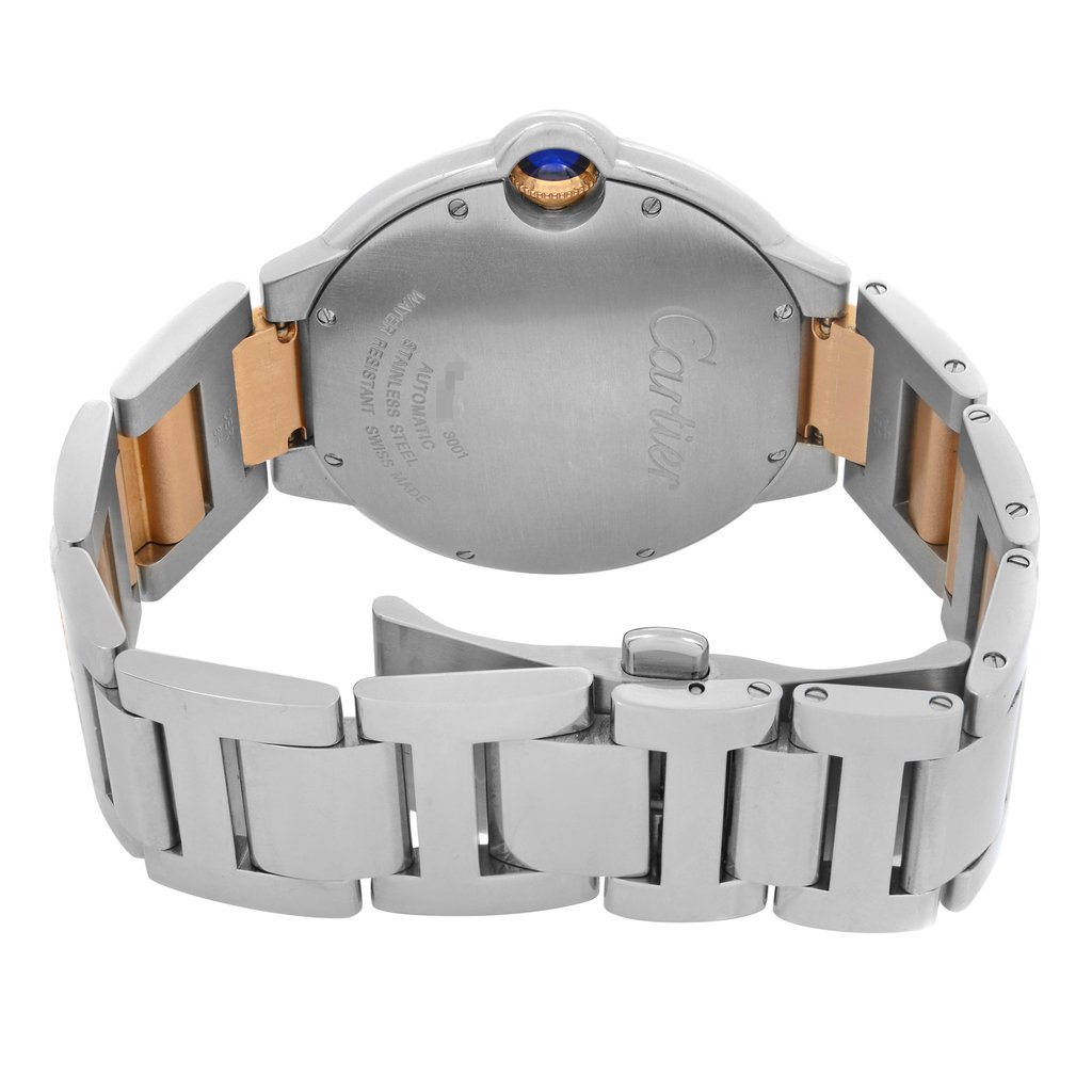 An image of a pre-owned Cartier men's wristwatch with a back view showing the closed clasp. The watch is positioned with the clasp facing toward the camera, at a straight-on angle, occupying the central portion of the frame at a close distance. The caseback, made of stainless steel, features engraving that includes the brand name and other details. The watch band is a combination of stainless steel and 18k rose gold, highlighting a two-tone appearance. It is equipped with a fold-over clasp with double push button for secure closure. 