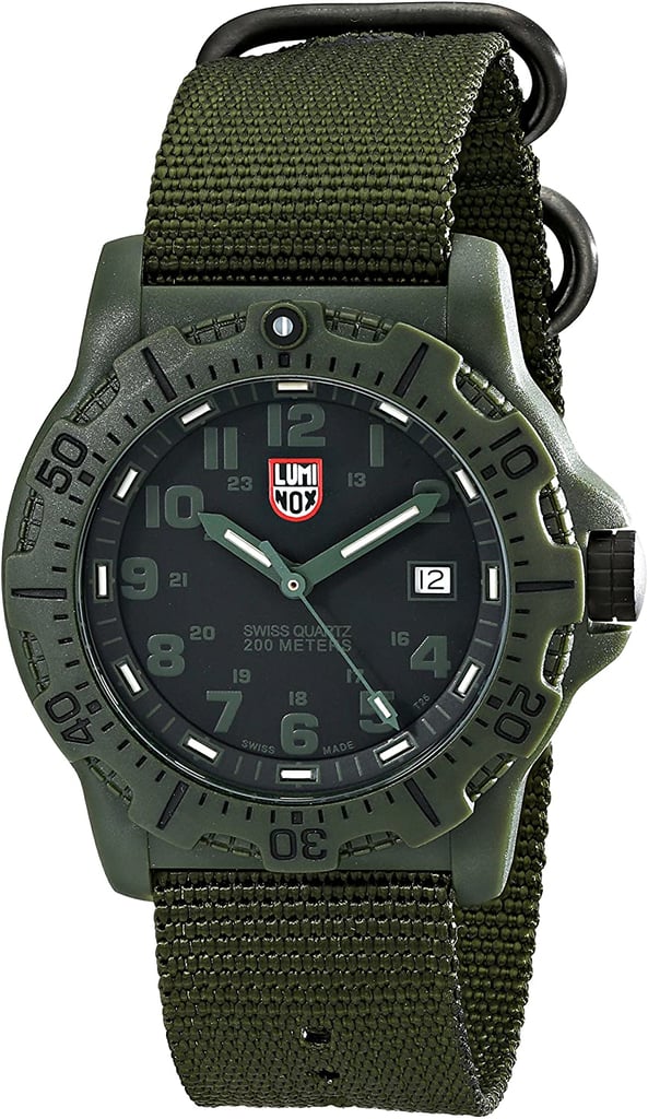 An image of a Wristwatch by Luminox. This Display Model item is designed for Men, featuring a Casual,Diver style. It has a Quartz movement and an Analog display with a Black dial color. The indices include 12-Hour Dial,Arabic Numerals,Easy to Read/Large Numerals. The band is made of Nylon and the case is made of Carbon. The watch has a Round shape with a case size of 45 mm and a case thickness of 13 mm.