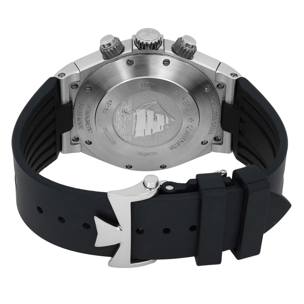An image of a pre-owned Vacheron Constantin men's wristwatch. The watch is positioned at a slight angle, showcasing the back view. It features a stainless steel case with three crowns on the side, and a black rubber strap with a distinctive buckle. The case back is engraved with a ship design and various inscriptions. The image is captured from a close distance, highlighting the watch's details and craftsmanship.