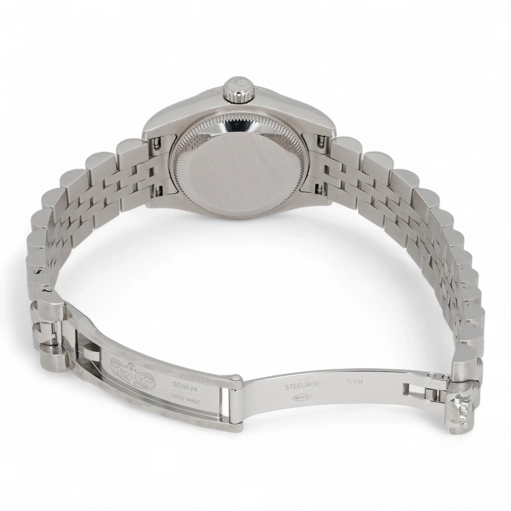 An image of a pre-owned women's Rolex wristwatch viewed from the back at a slight angle, showcasing the stainless steel case and bracelet. The watch is positioned horizontally, with the clasp open, displaying the branding and details on the inside. The image is taken from a close distance, highlighting the watch's polished finish and craftsmanship.