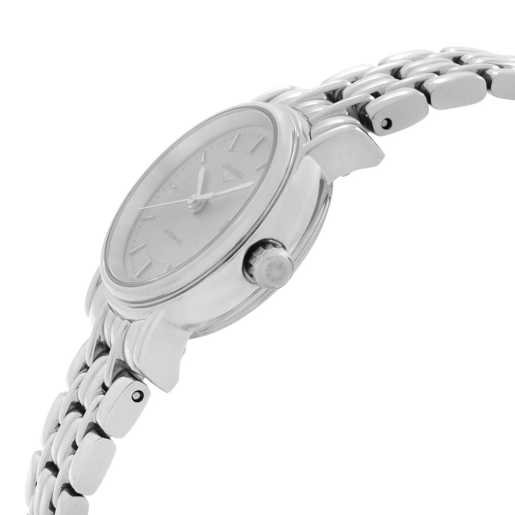 An image of a wristwatch taken from a side profile view, showcasing the watch's crown prominently. The watch features a metallic band and a sleek, minimalist face. The angle highlights the watch's polished finish, capturing its elegant design as a display model. The photograph is taken at a close distance, emphasizing the craftsmanship and details of the timepiece.