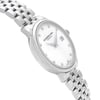 An image of an unworn RAYMOND WEIL women's wristwatch in a dress/formal style, featuring a white mother of pearl dial and a round stainless steel case. The watch is presented in a side profile view opposite the crown, showcasing the stainless steel band. The angle provides a clear view of the watch's side, emphasizing its sleek design and the reflective surface of the metal. The distance is close-up, providing detail of the watch face and band.