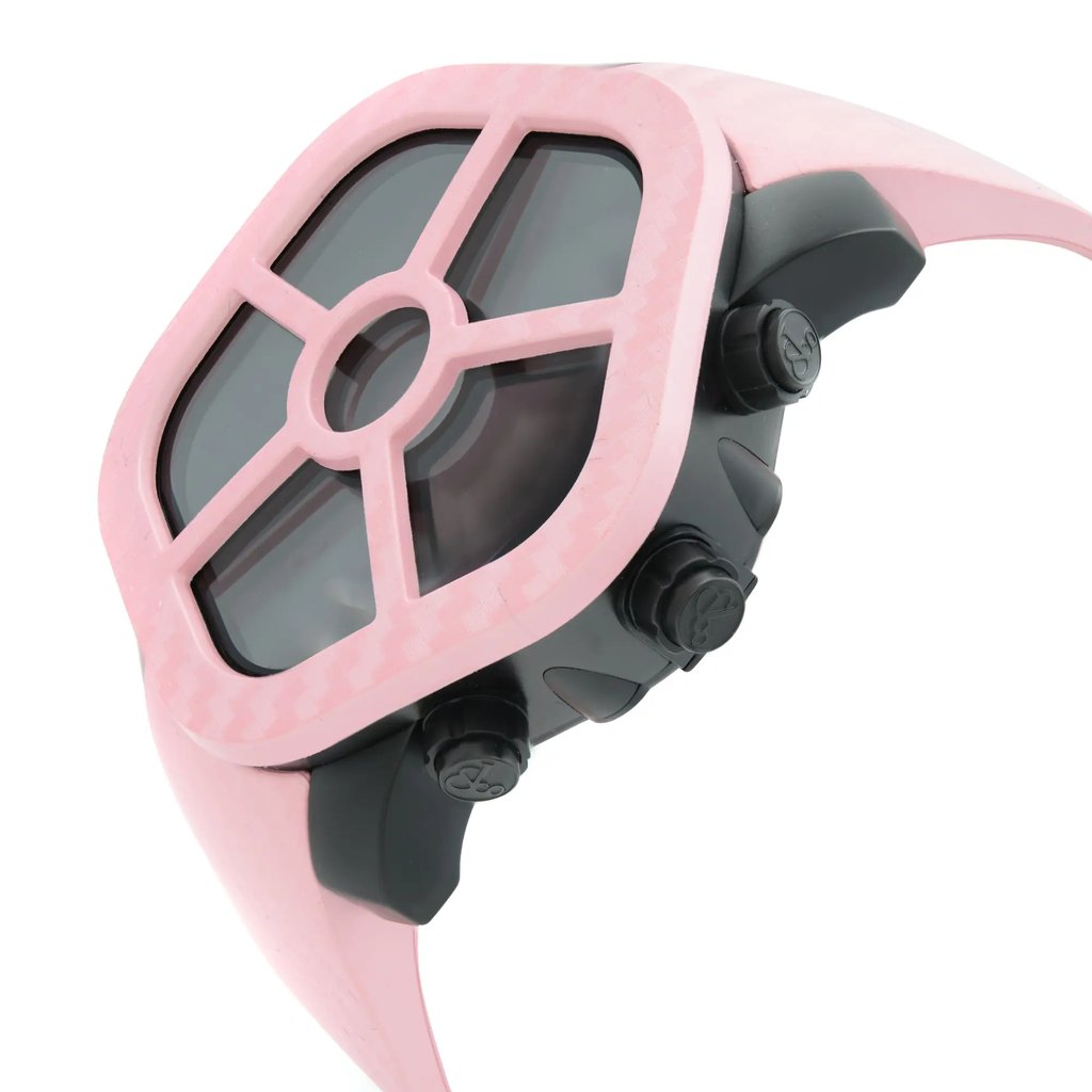 An image of a wristwatch in a side profile view, highlighting the crown. The watch features a distinctive design with a pink case and a dark inner frame. The angle showcases the watch's side, emphasizing the black crown and buttons. The image is taken from a close distance, allowing for detailed observation of the watch's features.