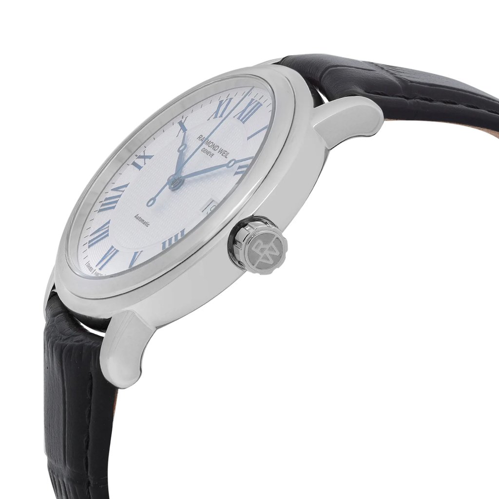 An image of a Raymond Weil men's wristwatch in excellent condition, displayed from a side profile view. The focus is on the stainless steel crown, featuring the brand's logo. The watch has a round shape with a steel bezel, a silver tapisserie-patterned dial, and a date indicator. The band is made of black leather, contributing to its formal dress style. The angle highlights the crown and part of the dial, showing the elegant design details.