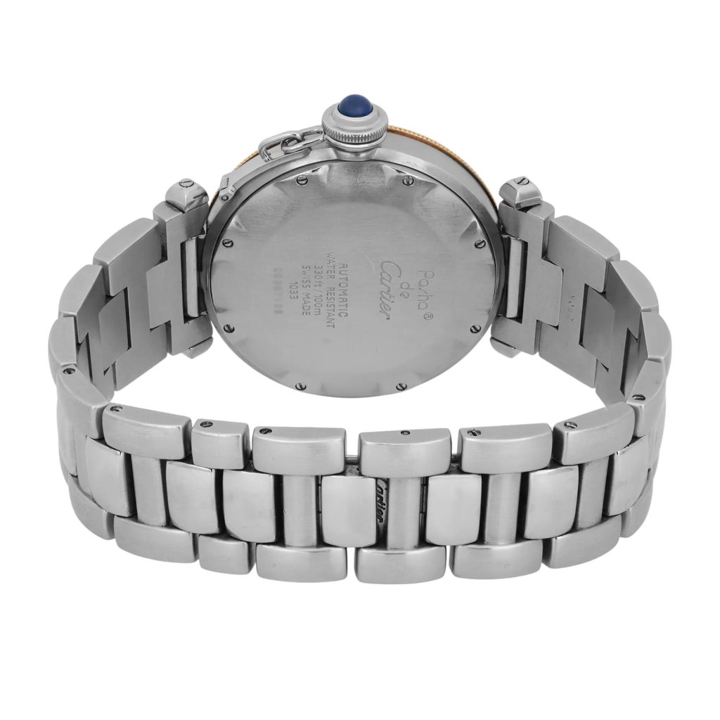 An image of a pre-owned Cartier men's wristwatch, featuring a stainless steel metal bracelet and a round case. The watch is positioned with its back facing the viewer, showcasing engraved details. The photo is taken at a slightly elevated angle, providing a clear view of the bracelet links and the crown with a blue accent. The watch is centered in the frame, photographed from a moderate distance.