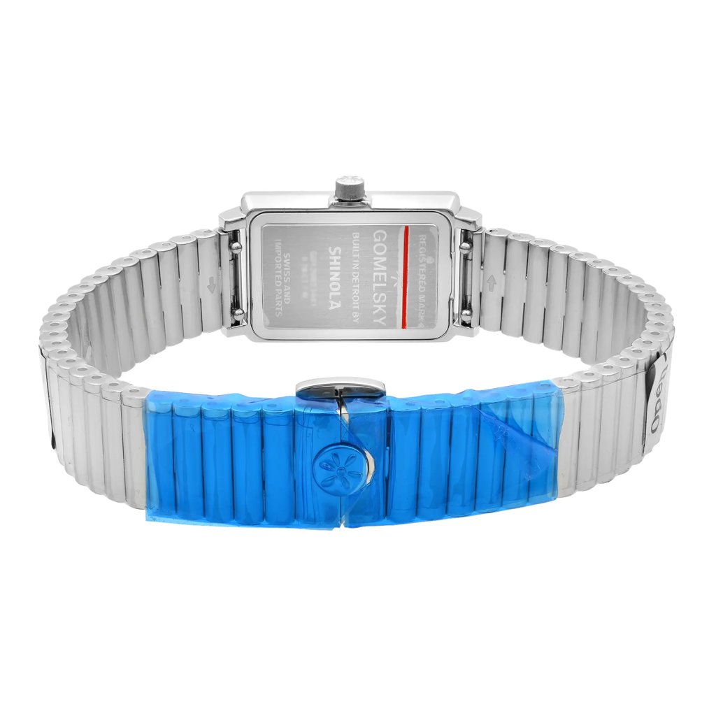 An image of a wristwatch shows the back view with the clasp closed. The watch features a rectangular case with visible engravings on the back. The metal band is partially covered with blue protective film. The angle is straight on, providing a clear view of the watch's back. The image is taken from a close distance to highlight the details of the watch's construction and condition, which is unworn.