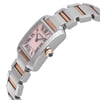 An image of a pre-owned Cartier women's wristwatch in a luxury style, presented in a side profile view with the crown visible. The watch features a mother of pearl dial with Roman numeral markers, set within a rectangular stainless steel case with a gray bezel. The band is made of alternating rose gold and stainless steel links. The position of the watch shows it at a close distance, with the side angle focusing on the watch's face and crown, which is adorned with a blue accent.