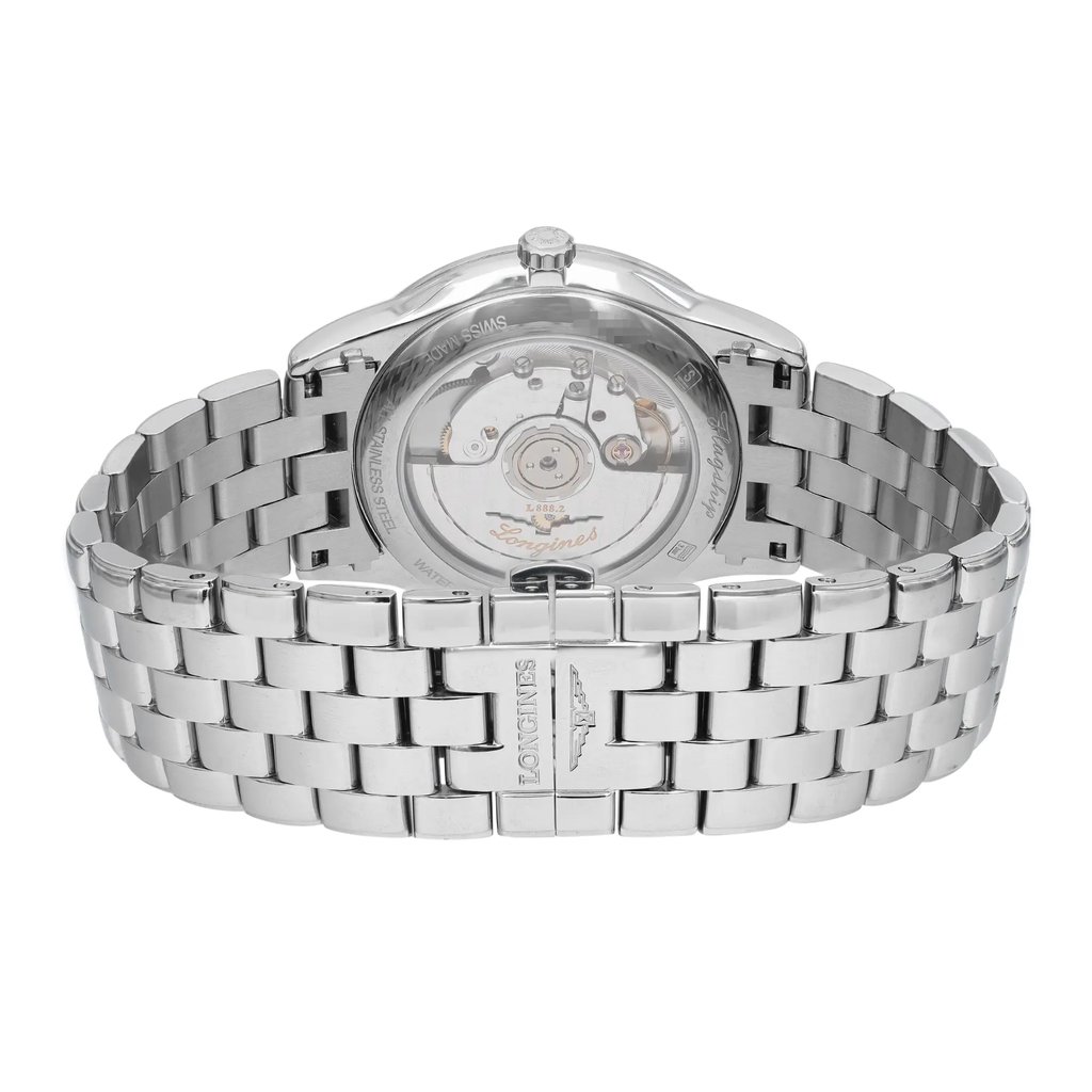 An image of a wristwatch shown from the back view, focusing on the close clasp. The watch features a stainless steel bracelet with a polished, interlocking design. The case back reveals the internal mechanism, showcasing its intricate components. The angle is straight-on, and the watch is positioned at a close distance, emphasizing the detailed craftsmanship.