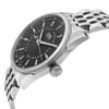 An image of a wristwatch taken from a side profile view, showcasing the crown prominently. The watch features a sleek, stainless steel body and a dark dial with clearly visible hour markers and hands. The metal bracelet is partially visible, displaying its polished links. The perspective highlights the watch's elegant design and craftsmanship, set against a plain background.