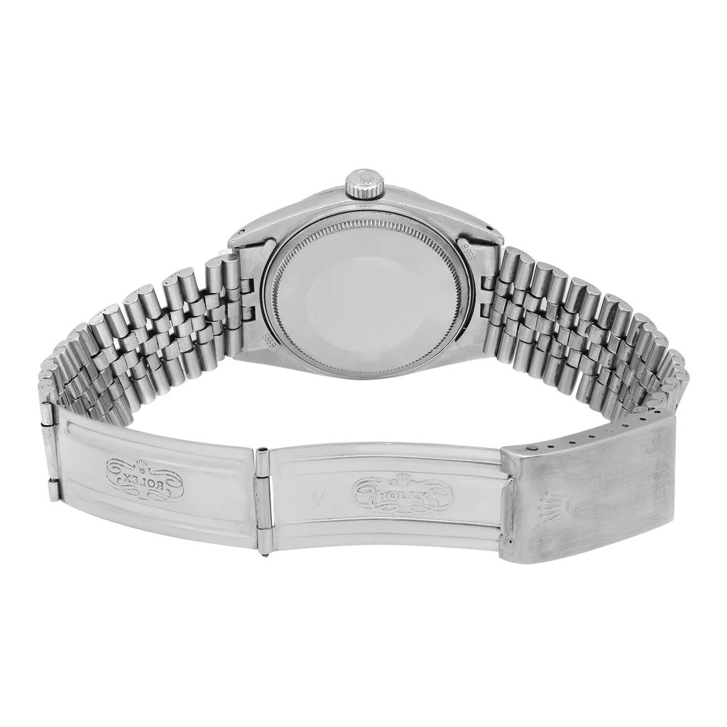An image of a pre-owned wristwatch showcasing the back view with an open clasp. The watch is positioned centrally, with the camera capturing it from a slight overhead angle at a close distance. The metal bracelet is fully extended, revealing the inner side of the clasp and the watch case back.