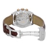 An image of a pre-owned wristwatch shown from the back view with an open clasp. The focus is on the transparent case back, revealing the intricate mechanical movement inside. The watch has a stainless steel and gold-tone case, with engraved labels around the edge. The brown leather strap is partially visible, and the clasp is open, showcasing the brand name. The photograph is taken at a close angle, emphasizing the watch's craftsmanship and details.