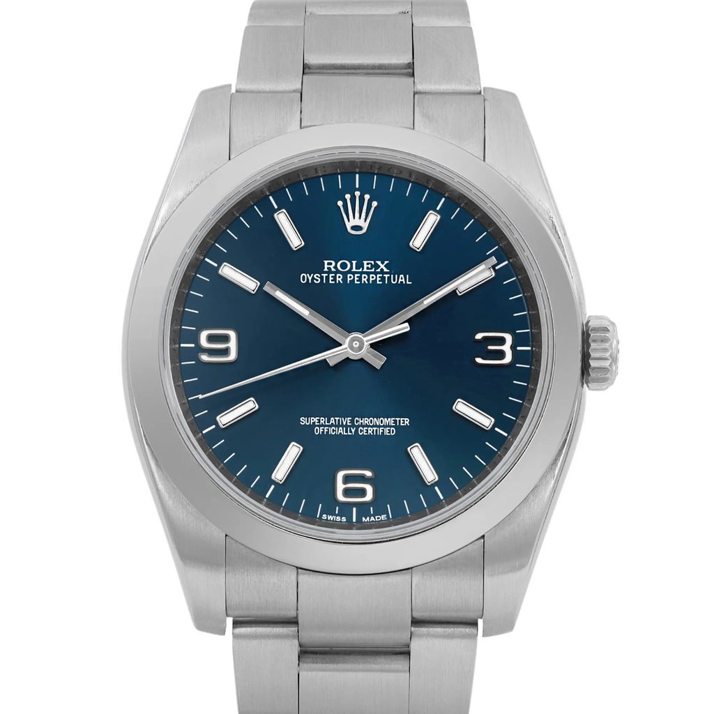 An image of a pre-owned wristwatch, featuring a front close-up shot of the watch face. The watch has a sleek metal band and a deep blue dial with silver hour markers and hands. The brand logo is visible at the top of the dial, with additional text indicating its certification. The crown is positioned on the right side of the case. The angle captures the watch face directly, highlighting its elegant design.