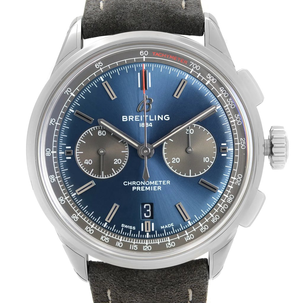 An image of a front close-up shot of a Breitling men's wristwatch, showcasing a round blue sunburst dial with stick indexes, two subdials, and a date window at the 6 o'clock position. The watch has a stainless steel case with a steel bezel, and is attached to a leather band. The watch is positioned directly facing the camera, allowing clear visibility of the dial details and brand logo. The image is taken from a close distance, capturing the entire watch face and part of the leather strap. The watch is a display model and has never been worn, there may be minor blemishes on the band due to store handling.