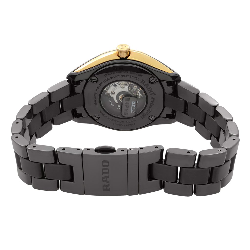 An image of a pre-owned women's Rado wristwatch viewed from the back. The focus is on the exhibition caseback and the ceramic band with a fold-over clasp featuring a double push button. The watch is positioned horizontally, showcasing the round stainless steel and ceramic case, with the gold-toned crown visible at the top. The angle highlights the intricate details of the clasp and the movement inside the caseback, emphasizing its luxurious materials and design.