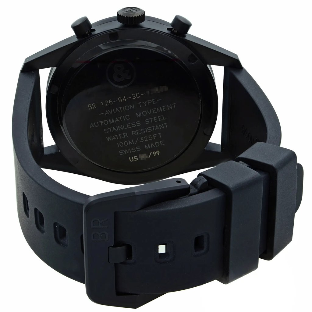An image of a black wristwatch shown from a rear angle, focusing on the back casing and the strap. The back of the watch displays engraved text detailing the type, movement, material, water resistance, and origin. The distance from the camera allows for a clear view of these details and the overall design of the watch.